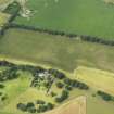 Oblique aerial view of the cropmarks of the roundhouses at Anniston Cottages, taken from the SE.