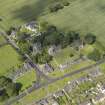 Oblique aerial view of Dalmeny centred on St Cuthbert's Church, taken from the SSW.