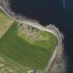 Oblique aerial view of the excavated settlement, broch and lairds house at Jarlshof, taken from the NNE.