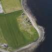 Oblique aerial view of the excavated settlement, broch and lairds house at Jarlshof, taken from the NW.
