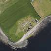 Oblique aerial view of the excavated settlement, broch and lairds house at Jarlshof, taken from the W.
