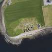Oblique aerial view of the excavated settlement, broch and lairds house at Jarlshof, taken from the SW.