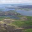 General oblique aerial view of Busta Voe and Brae village with Sullom Voe beyond, looking NE.