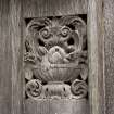 Coach house, arched entrance door, detail of carved panel