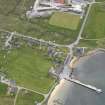 Oblique aerial view of Mid Yell centred on the pier, looking SW.