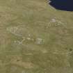 Oblique aerial view centred on the remains of the field systems, clearance cairns, heel-shaped cairn, buildings and enclosures at Flatpunds, looking SE.