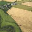 Oblique aerial view of the excavation trench with Forteviot village beyond, taken from the SW.