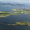 Oblique aerial view across the Loch of Harray with the Ring of Brodgar in the foreground and Hoy beyond, taken from the NE.