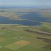 General oblique aerial view looking across the Loch of Stenness towards the Ness of Brodgar, taken from the S.
