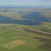 General oblique aerial view looking across the Loch of Stenness towards the Ness of Brodgar, taken from the S.