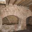 Interior. Kiln, view of arched openings at E end