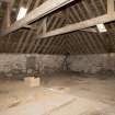 Interior. Hayloft, view showing roof structure