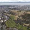 Oblique aerial view of Edinburgh centred on Holyrood Park and Salisbury Crags, taken from the SSE.