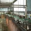 Bottling Plant. Interior. Bottling line between bulk glass de-palletiser and rinser from west