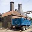 Belhaven Brewery. View from west of spent draff from brewing process being collected in a trailer.