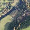 Oblique aerial view centred on the excavations of the round house and other archaeological features, taken from the WNW.