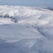 General oblique aerial view of Chew Green Roman fortlet and temporary camps, a scooped settlement and sheepfold in snow, looking ENE.