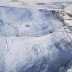 Oblique aerial view of the settlements and sheepfold under snow, looking to ESE.