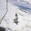 General oblique aerial view of scooped settlement and settlement  under snow, looking to NNE.