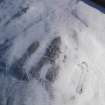 Oblique aerial view of palisaded enclosure, settlement and cord rig under snow, looking to SSE.