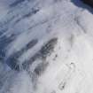 Oblique aerial view of palisaded enclosure, settlement and cord rig under snow, looking to SE.