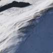 Oblique aerial view of palisaded settlement under snow, looking to WSW.