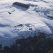 Oblique aerial view of Edin's Hall broch and fort under snow.