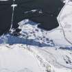 Oblique aerial view of the lime kilns and quarry under snow, looking SE.