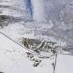 Oblique aerial view of fort and settlement under snow, looking W.