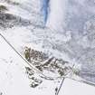 Oblique aerial view of fort and settlement under snow, looking WSW.