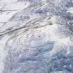 Oblique aerial view of White Meldon fort and cairn under snow, looking SSE.