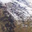 Oblique aerial view of settlement under snow, looking NE.