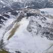 General oblique aerial view of the snow-covered remains of the fort at Hare Law, taken from the N.