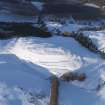 Oblique aerial view of Castle Law fort under snow, looking NNE.