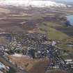 General oblique aerial view of Milnathort with the Lomond Hills beyond, looking WSW.