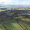 General oblique aerial view looking across the peat works at Gardrum Moss towards Falkirk and Grangemouth, taken from the SW.