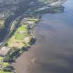 General oblique aerial view looking across the remains of the timber ponds and the playing fields towards Port Glasgow, taken from the ENE.