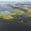 General oblique aerial view looking across the ash disposal site and remains of the colliery at Preston Island, towards Culross and Valleyfield, with the chimney of Longannet power station visible in the distance, taken from the ESE.