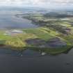 General oblique aerial view looking across the ash disposal site and remains of the colliery at Preston Island, towards Culross and Valleyfield, with the chimney of Longannet power station visible in the distance, taken from the E.