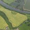 Oblique aerial view of the remains of the motte at Ladykirk, taken fromt he NW.