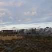 General view of the An Turas waiting room, Gott Bay, Tiree, taken from the West. This image shows cattle pens in the foreground, directly adjacent to the structure.