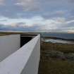 View of the An Turas waiting room, Gott bay, Tiree, taken from the higher ground to the South-East of the structure, looking along the length of the Eastern wall.
