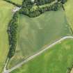 Oblique aerial view of the cropmarks of the ring ditch and field boundary, taken from the WSW.