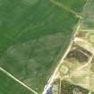 Oblique aerial view centred on the cropmarks of the field boundary and rig, taken from the W.