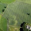 Oblique aerial view of the cropmarks of the enclosure with Spittalton farmstead adjacent, taken from the NNW.