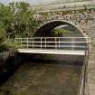 General view of bridge over the spillway leading from the leading the dam, from E.