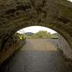 General view of the sluice leading from the leading the dam, from SE.