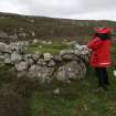 View from NW of Mr J Sherriff (RCAHMS) recording a peat stand at Stany Field, Walls and Sandness, Shetland.
