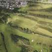 Oblique aerial view of the parchmarks of the barrow on Muir of Ord golf course, looking to the ENE.