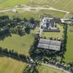 Oblique aerial view of Royal Brackla Distillery and Brackla House, looking to the NNW.